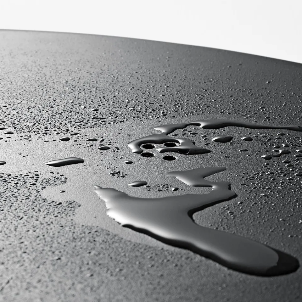 Close-up of water beading and draining off surface, demonstrating easy cleaning and efficient water runoff.