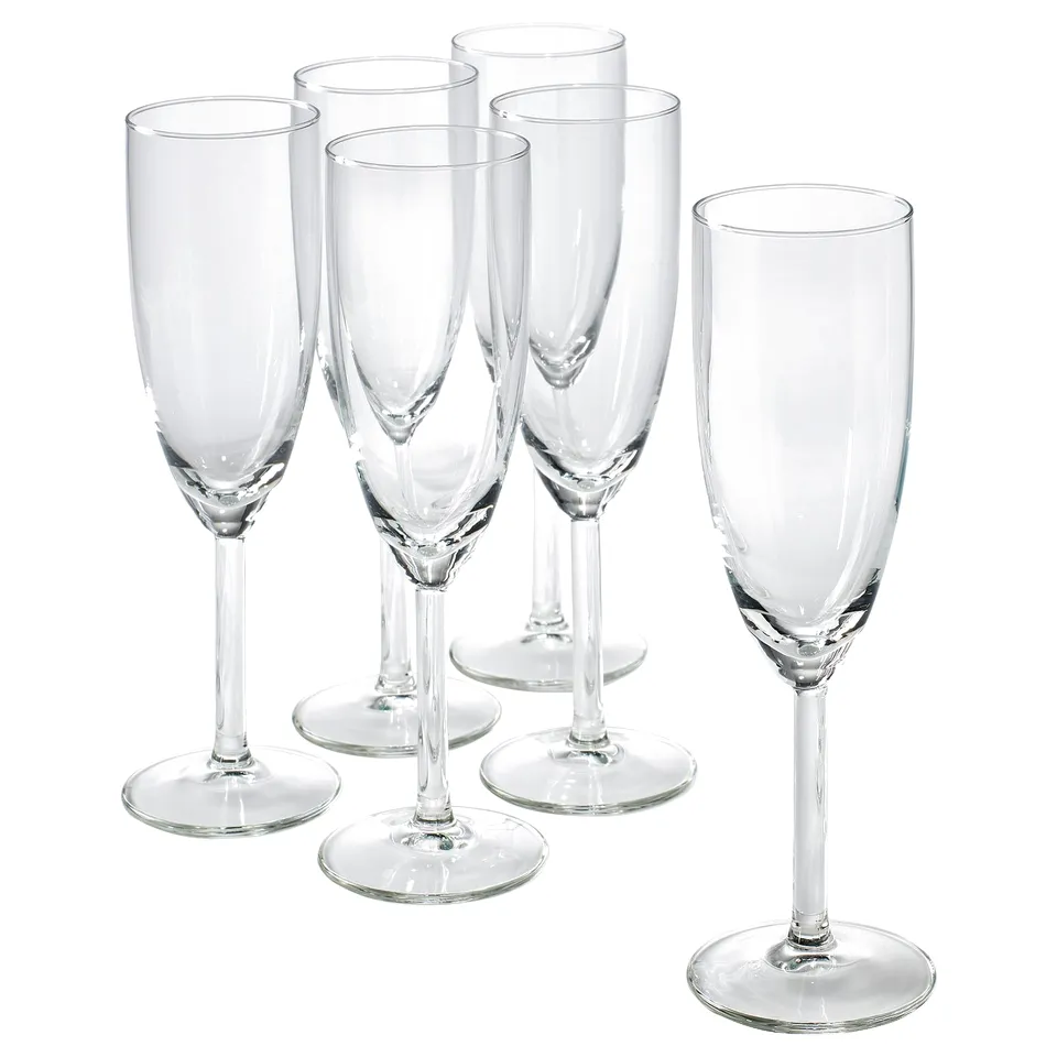 Six clear, slender SVALKA glasses made of glass, standing tall with a sleek design, perfect for champagne.