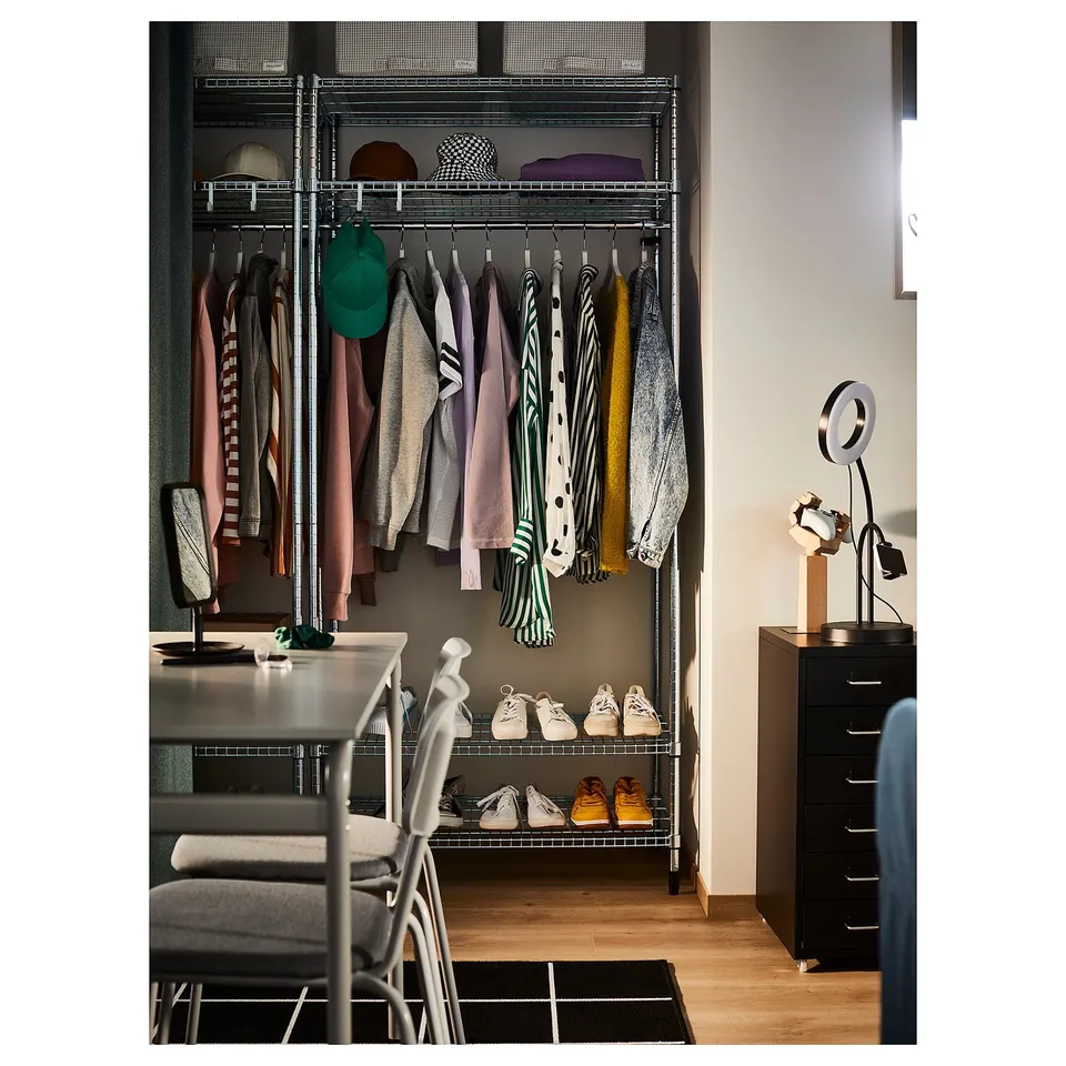 Modern closet with hanging clothes, shoes, and hats. Includes adjustable shelving, hanging rods, and metallic accents. Organised and stylish.