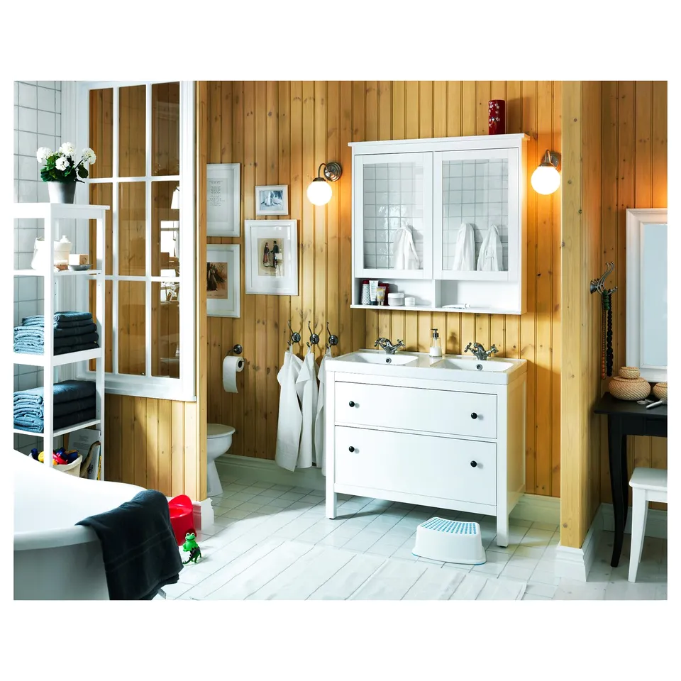 Organised bathroom with wooden panels, white HEMNES vanity, double sink, mirrors, and decor.