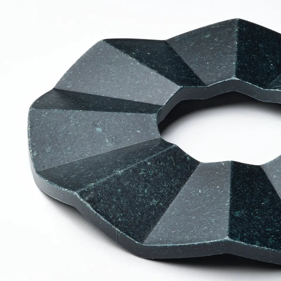 Black textured ring, intricate design.