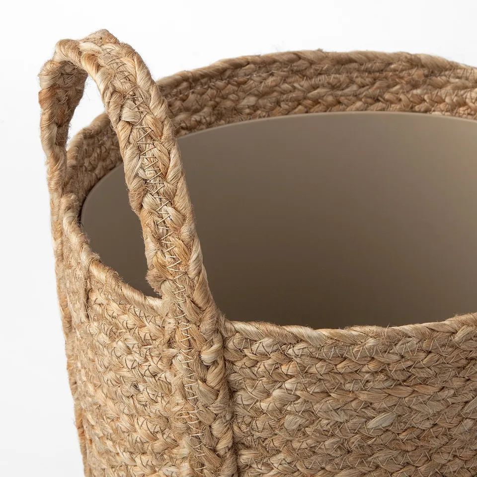 Handwoven jute and cotton plant basket, featuring sturdy handles and a natural, rustic texture.