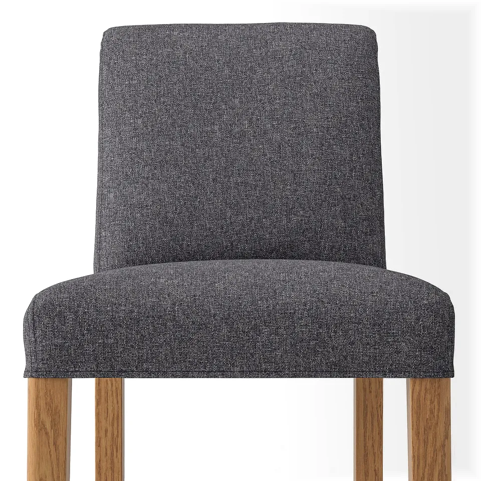 Grey upholstered bar stool with wooden legs. Comfortable, cushioned seat and backrest.