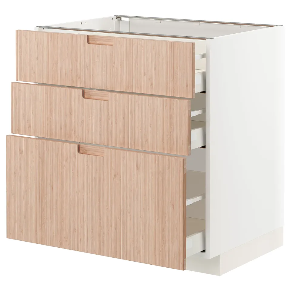 METOD kitchen unit with three light wood drawers.